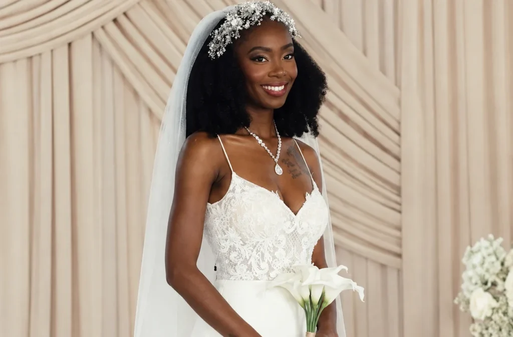 Black bride in lace wedding dress holding white calla lilies at The Valentine wedding venue